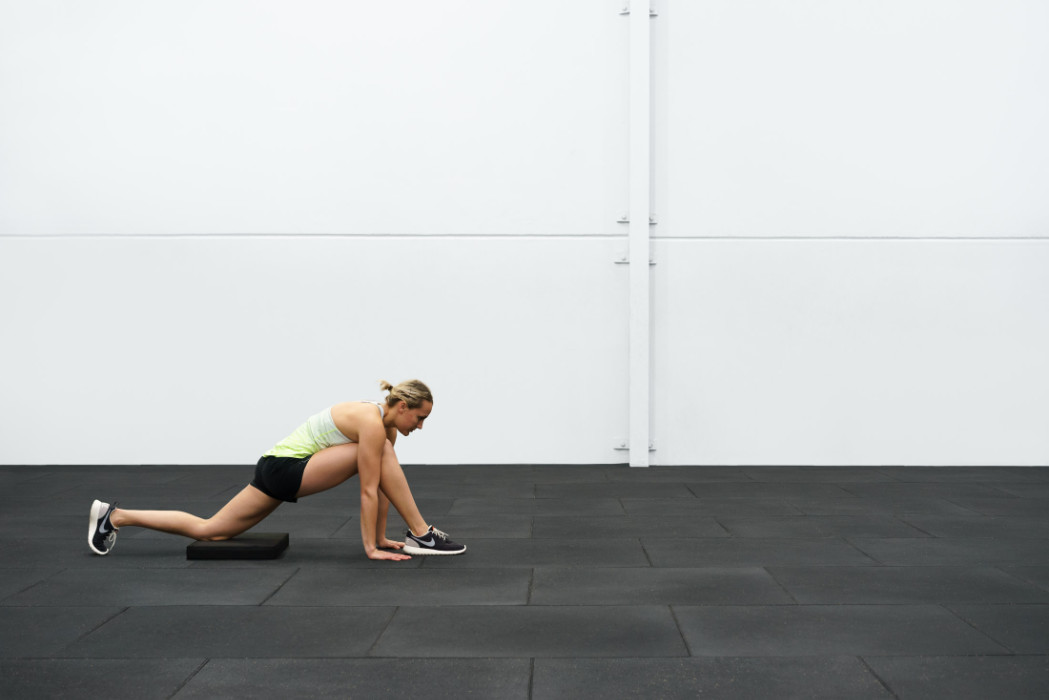 A female athlete stretching.