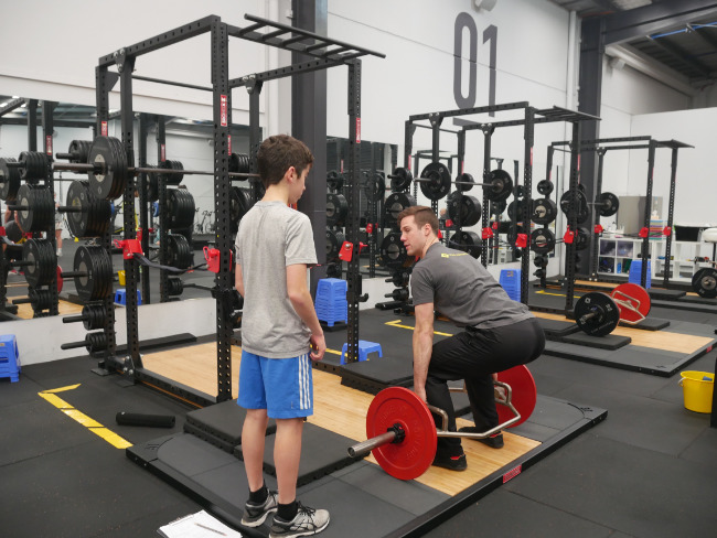 An image of Jack being instructed in the Core Advantage High Peformance Center