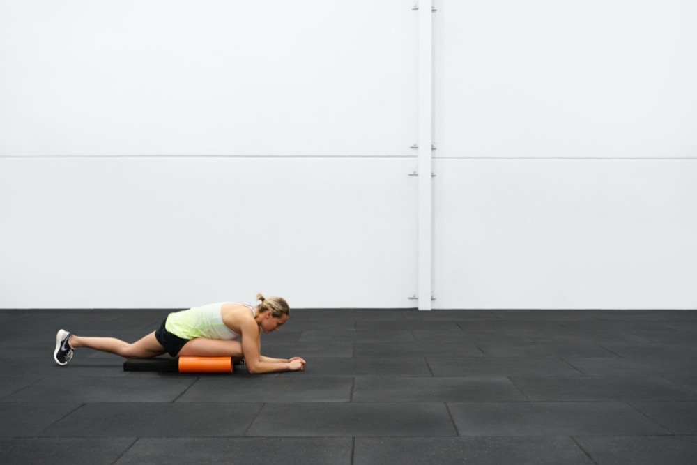 Demonstrating the lying glute stretch